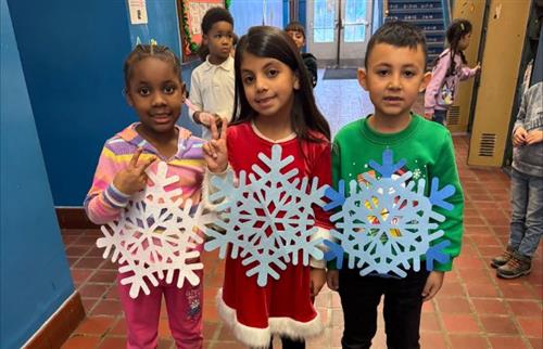 students posing with snow flakes
